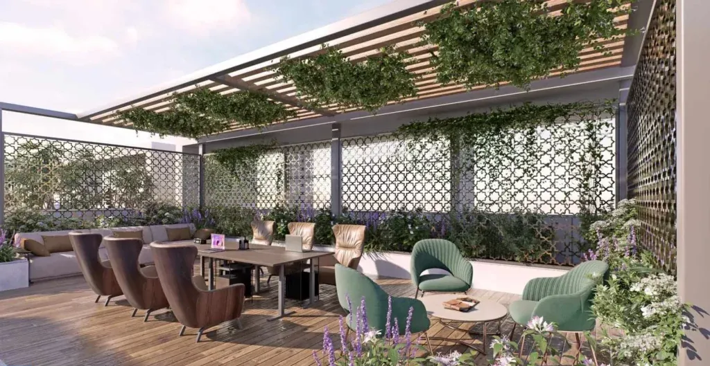 Rooftop co-working terrace under a green pergola at Elegant Atmos