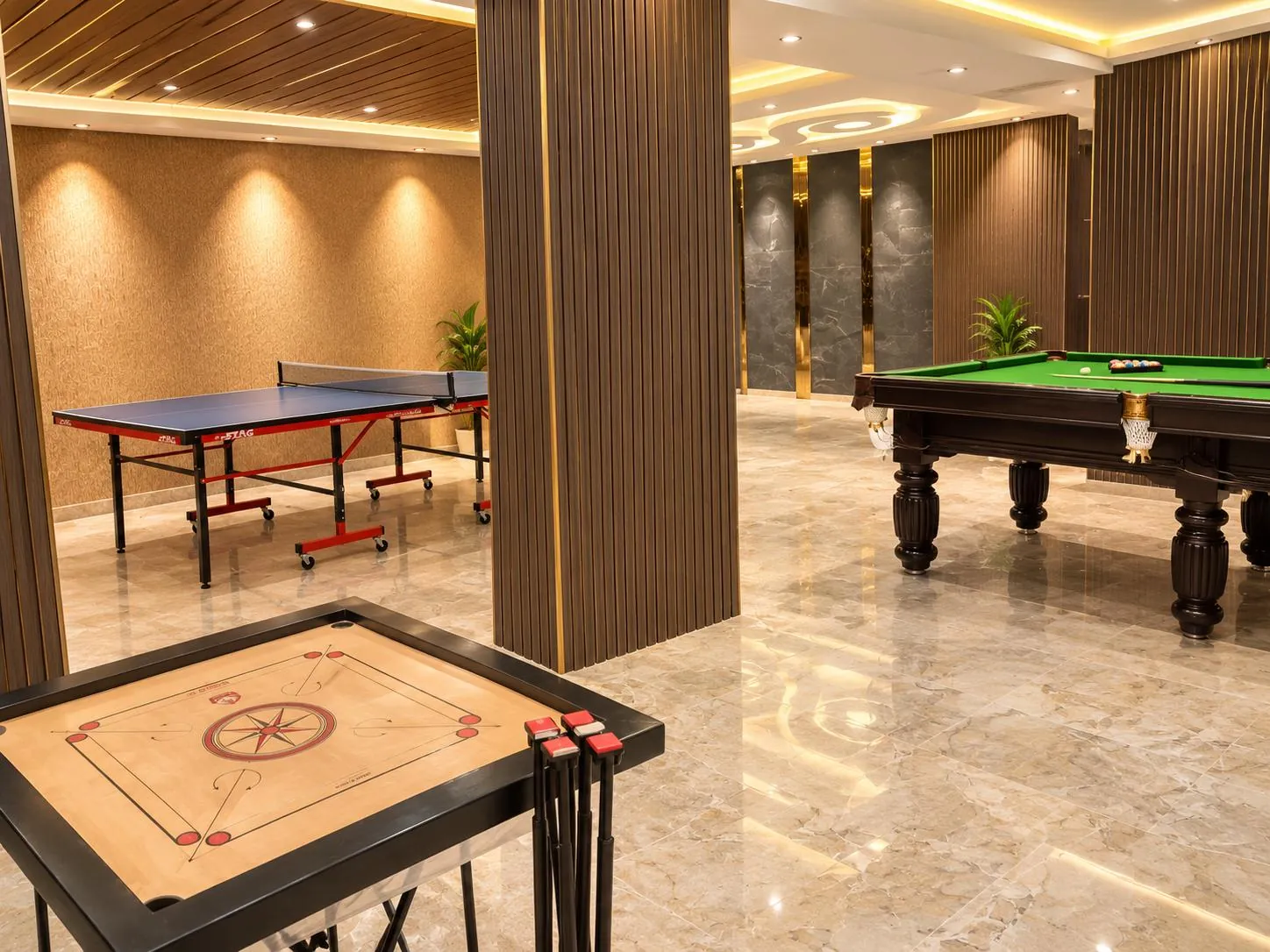 Indoor games room with pool table, table tennis and carrom at Premia (real image)