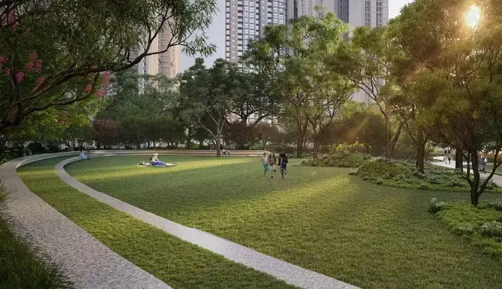 Open central lawn with a curved walking path between the Purvankara Northern Lights towers